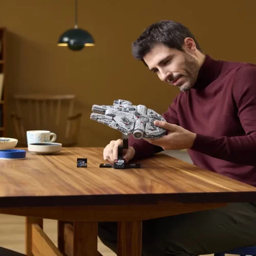 Adult collector holding Lego Star Wars Millennium Falcon