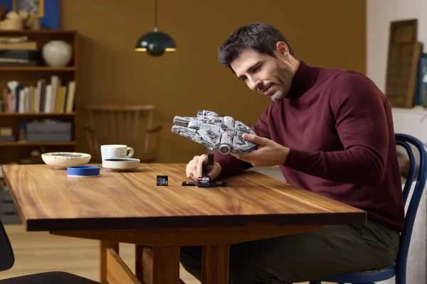 Adult collector holding Lego Star Wars Millennium Falcon