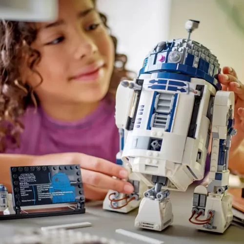 Child looking at Lego Star Wars R2-D2 set